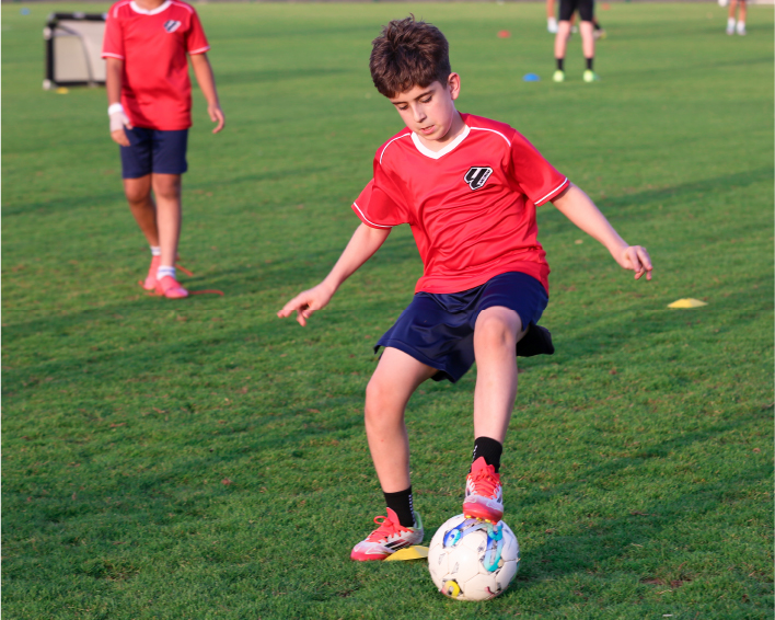 Youth football training on a grass pitch